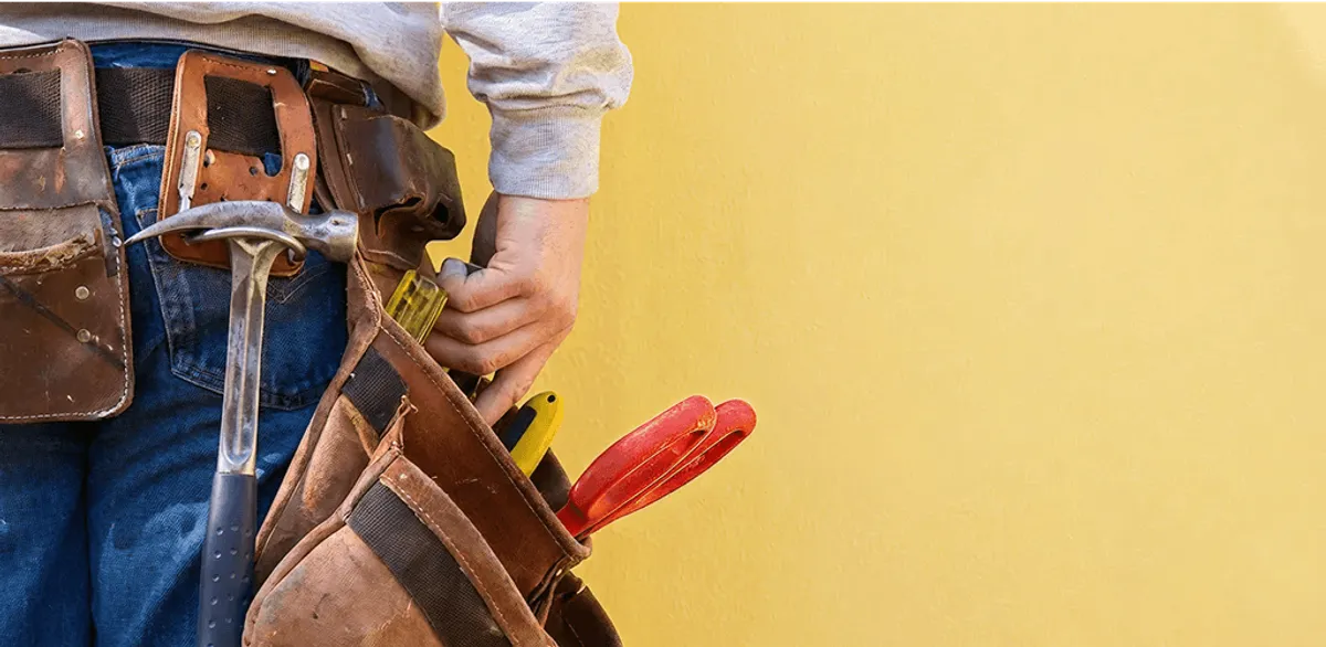 Handyman with tool belt ready for home repairs and maintenance in San Antonio, TX