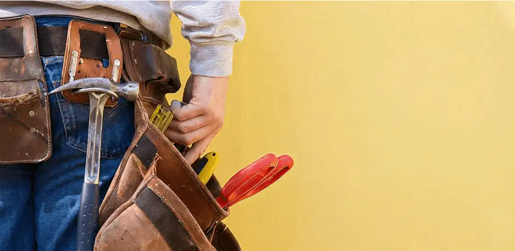 Handyman with tool belt ready for home repairs and maintenance in San Antonio, TX