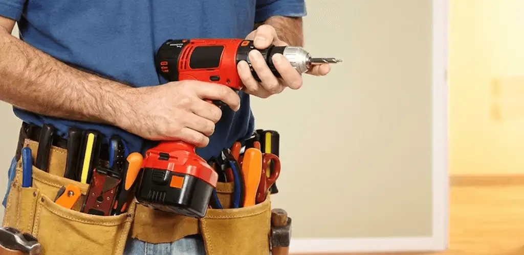 Handyman holding a power drill for home repairs and installations in San Antonio, TX