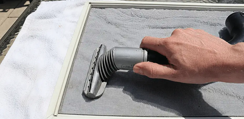 Window screen repair cleaning and fixing a damaged screen mesh in San Antonio, TX