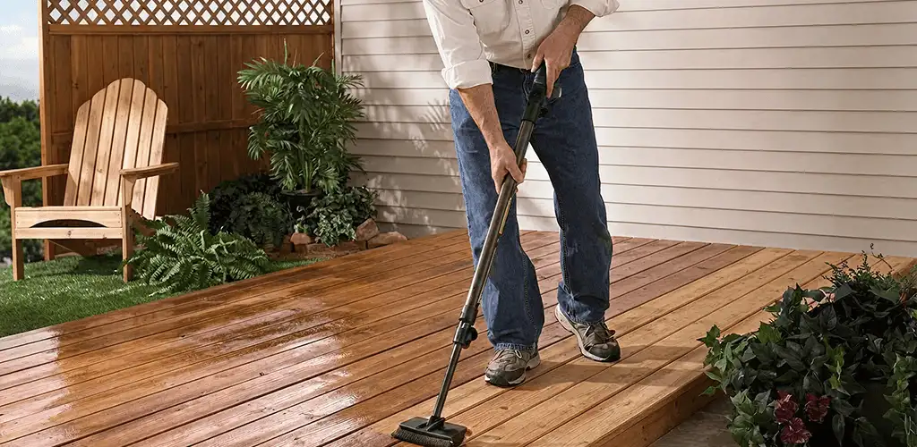 Deck staining service applying stain to a backyard wood deck in San Antonio, TX